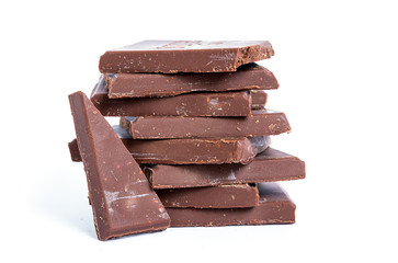 Cracked chocolate blocks stack on white background