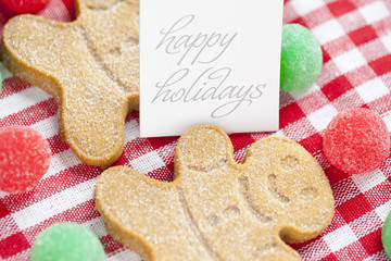 close-up shot of a happy holidays tag with gingerbread men.