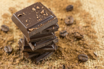 Top view of dark chocolate chunks on burlap texture