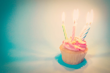 Pink Birthday cupcake with candle lighting