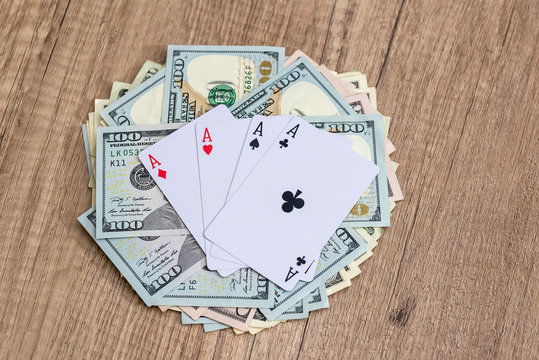 poker cards with dollar on wooden table