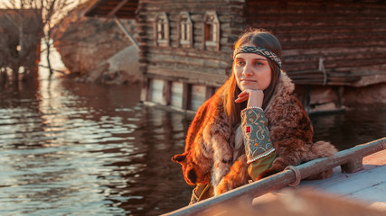 Fototapeta na wymiar Beautiful medieval north princess on the evening river backgroun