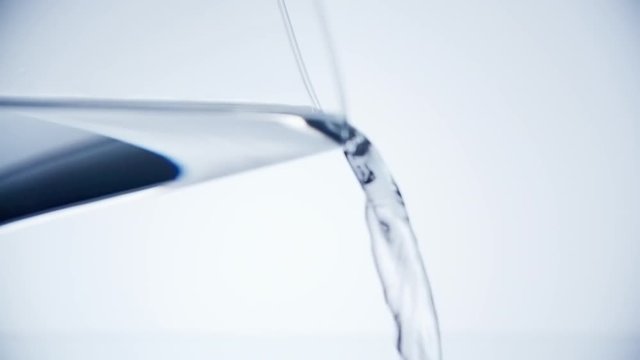 Close up of pouring clean drinking water from the glass