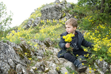 small mountain climber sits on top of the mountain