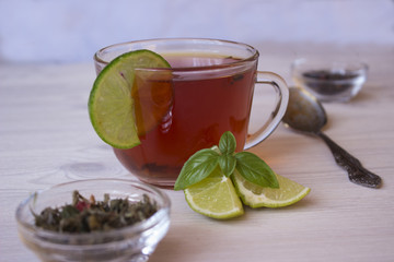 Hot tea with lime in a cup 