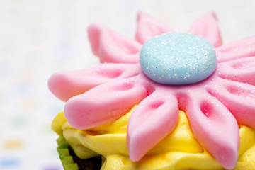 cropped image of a cupcake with floral pattern.