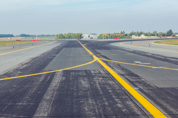 yellow lines on a runway of small airport
