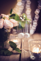 Elegant vintage wedding table decoration with roses and candles