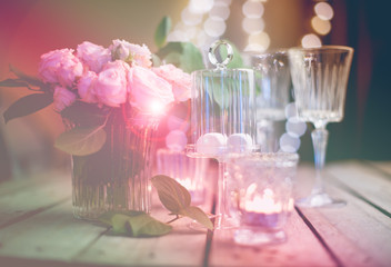 Elegant vintage wedding table decoration with roses and candles