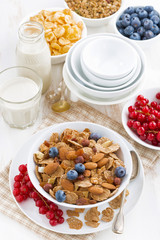 breakfast with cereals flakes and berries, top view