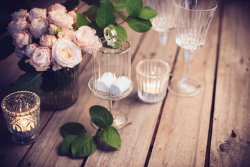 Elegant vintage wedding table decoration with roses and candles