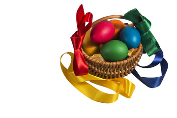 Easter Wicker basket with pink vines painted chicken eggs on a white background and on the basis of...