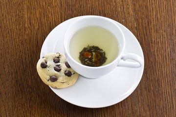 lime tea with chocolate chip cookie on saucer