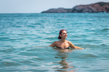 Sexy Young Woman in Bikini Enjoying Summer Sun during holidays in the Sea, Crete