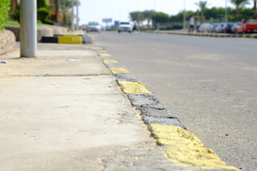 black and yellow lines on old asphalt, road surface