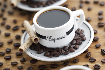coffee cup and saucer with cookie stick