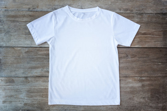 Top view of color T-Shirt on grey wood plank