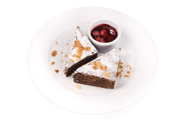 slice of delicious chocolate cake with berry jam isolated 
