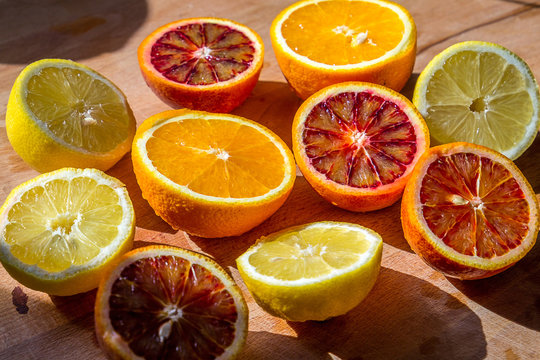 Fresh Citrus Fruits Half Cut on Woodend Background