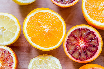 Fresh Citrus Fruits Half Cut on Woodend Background