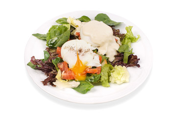 Eggs Benedict- toasted English muffins, salmon, poached eggs, and delicious buttery hollandaise sauce on salad 