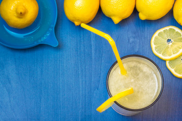 Lemonade with lemons and juicer