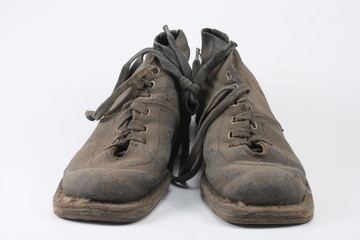 Old dusty shoes on a white background