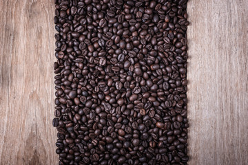 Coffee beans on wooden background, Composition with free space o