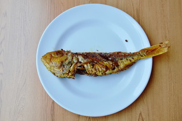 deep fried red snapper with turmeric powder on plate