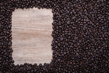 Coffee beans on wooden background, Composition with free space o