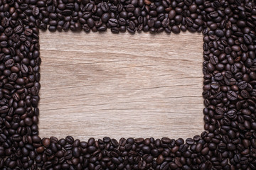 Coffee beans on wooden background, Composition with free space o