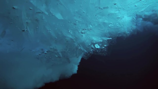 Unique extreme underwater shooting scuba dive beneath ice at geographic  North Pole in cold waters. Fantastic views of the lump of ice in water. ICE CAMP BARNEO, NORTH POLE, ARCTIC - APRIL 2015