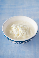 Delicious creamy filling of Apulian burrata cheese, called stracciatella. Selective focus.
