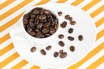 heap of coffee beans in coffee cup.