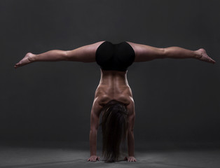 Young girl training. Standing on hands.