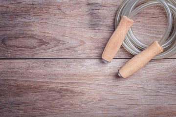 Skipping rope on wooden table top view