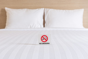 NO SMOKING Sign on the bed in hotel room