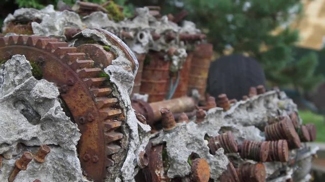 Broken old engine overgrown in stoun