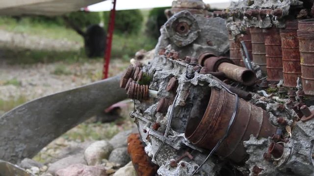 Broken old engine overgrown in stoun