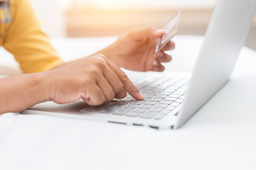 Woman hands holding credit card in front laptop. Online shopping