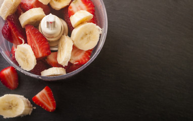 strawberry banana fruit in a blender ready to blend