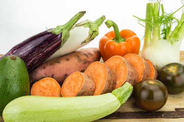 Fresh vegetables on wooden table with white background