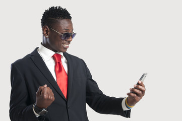 Handsome black businessman with smart phone