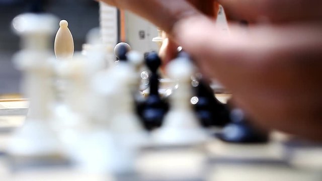 men playing chess outdoors    /    men playing chess outdoors, vintage pieces, concept passion and competition, close-up