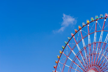 Ferris wheel against blue sky background