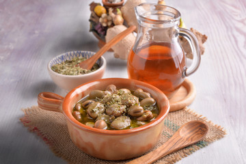 earthenware dish with beans cooked in olive oil and oregano