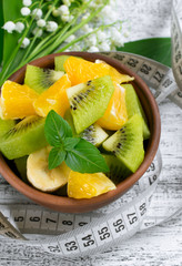 Fruit salad with kiwi, banana and orange for slimming and centim