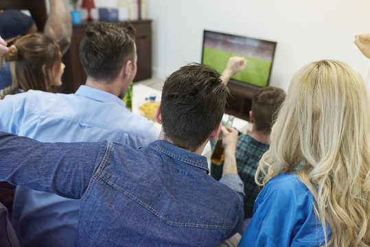 Fans of soccer watching match.