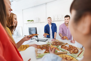 happy business team eating pizza in office