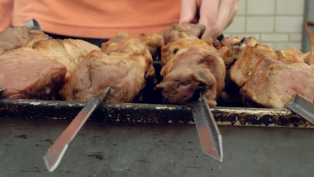 Barbeque skewers with meat cooking on hot coal ember brazier Outdoors picnic concept. 4K UHD video footage.